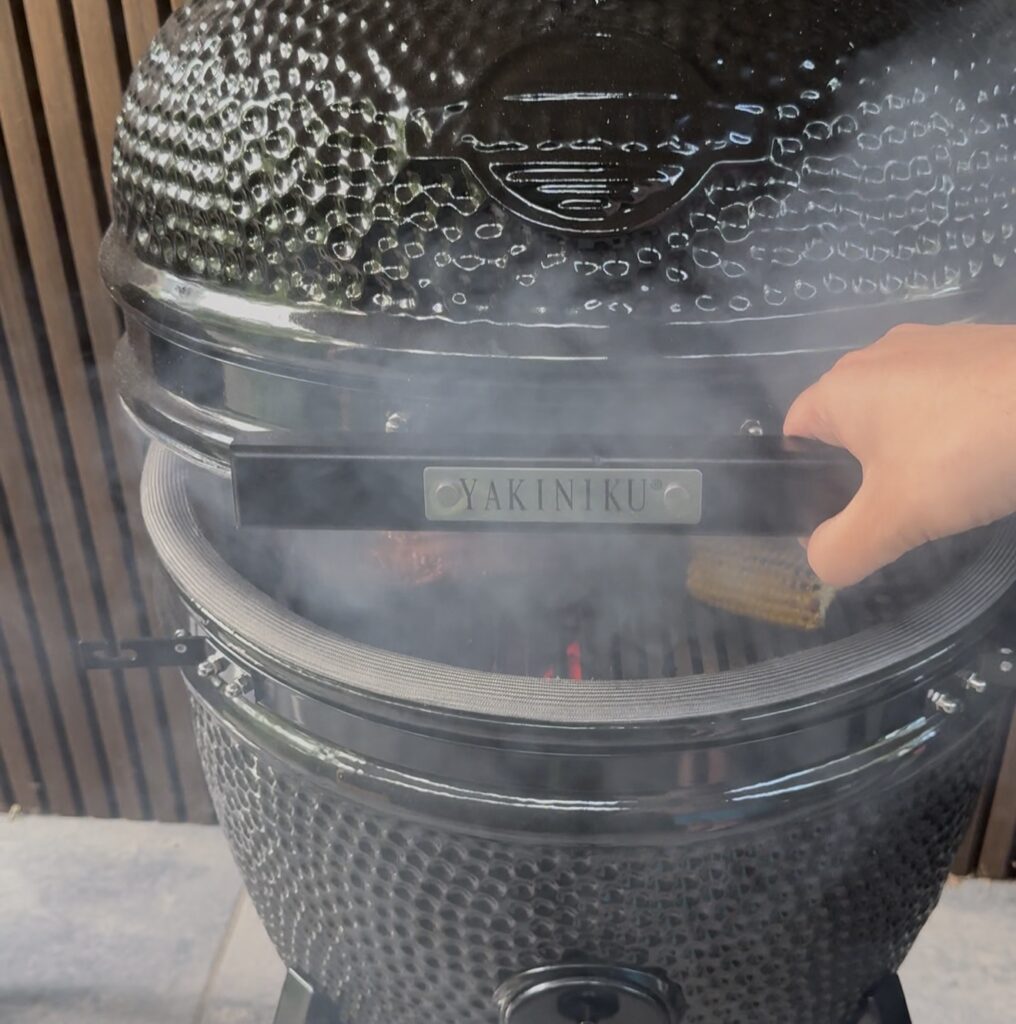 Kamado deksel op hoge temperatuur op een kier een paar centimeter op en neer wapperen om een backdraft te voorkomen (burp-protocol)